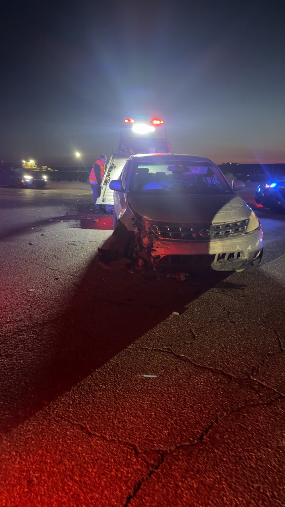Bradley's Towing working a recovery at night with emergency lights