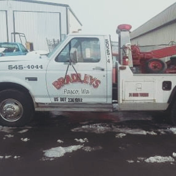 The Bradley's Towing wrecker, Pasco WA, with the company name and phone painted on the door